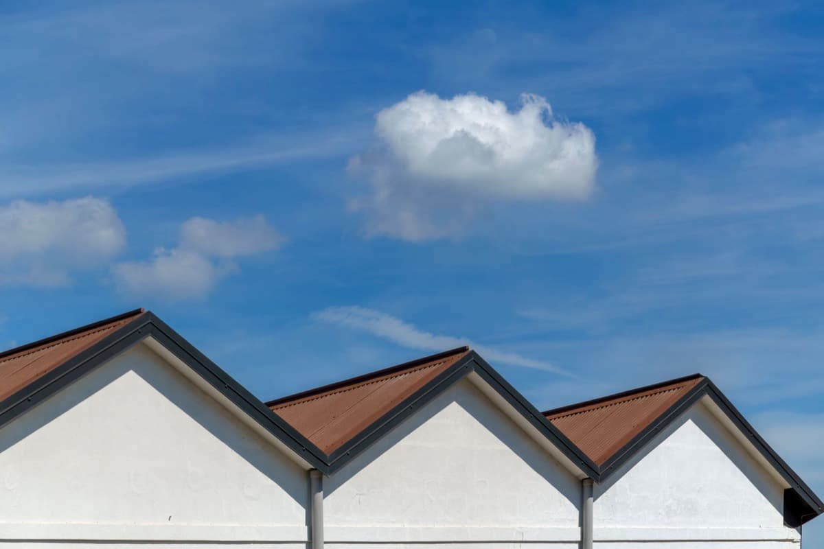 Three crisp gable rooflines against a blue sky